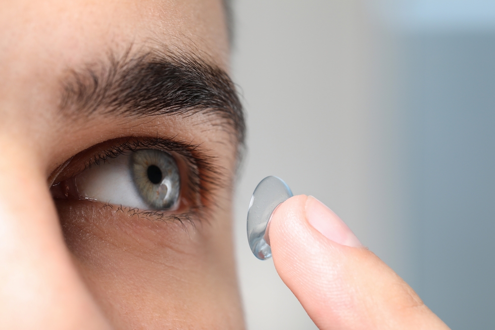 Close-up of a contact lens held near the eye before insertion, representing precision, comfort, and professional contact lens fitting – Contact Lenses Plymouth